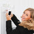 Woman installing Feit Electric smart LED floodlight camera